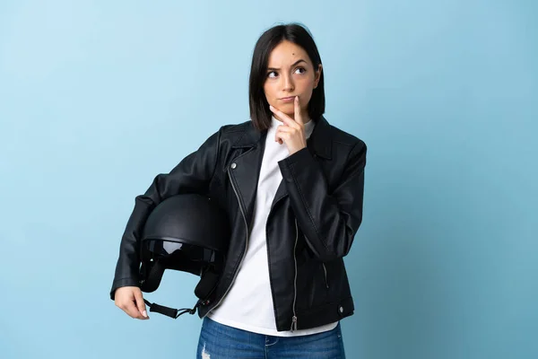 Woman Holding Motorcycle Helmet Isolated Blue Background Having Doubts While — ストック写真