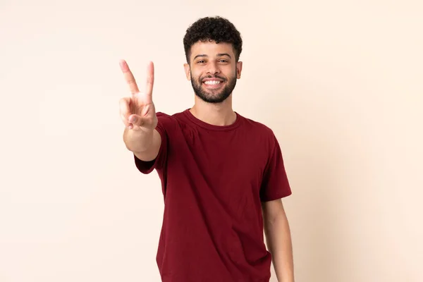 Young Moroccan Man Isolated Beige Background Smiling Showing Victory Sign — Stock Photo, Image