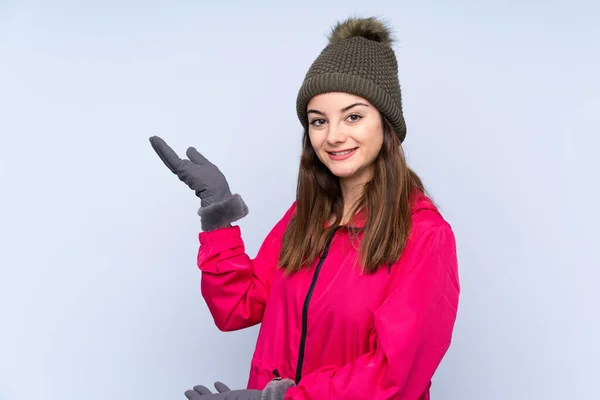 Young Girl Winter Hat Isolated Blue Background Extending Hands Side — Stock Fotó