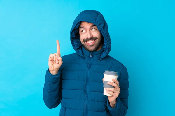 Man Wearing Winter Jacket Holding Takeaway Coffee Isolated Blue Background — Foto Stock