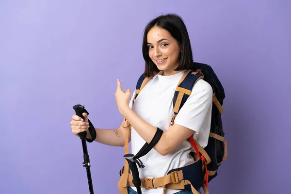 Young Caucasian Woman Backpack Trekking Poles Isolated Blue Background Pointing — Stock Photo, Image