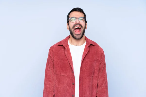 Young Caucasian Man Wearing Corduroy Jacket Blue Background Shouting Front — Stok fotoğraf