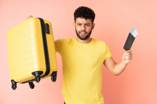 Young Moroccan Man Isolated Pink Background Unhappy Vacation Suitcase Passport — Stockfoto