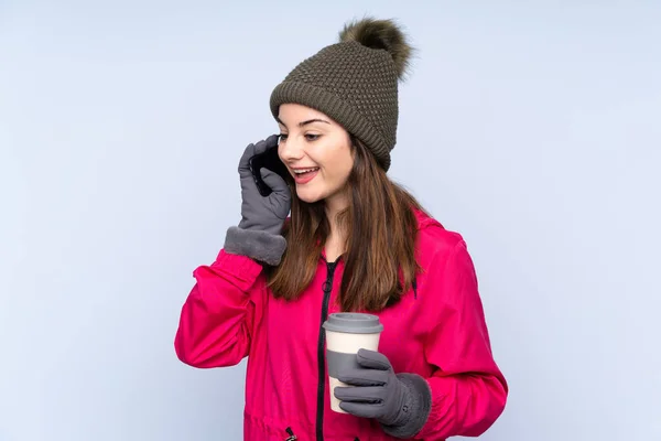 Young Girl Winter Hat Isolated Blue Background Keeping Conversation Mobile — Stock Photo, Image