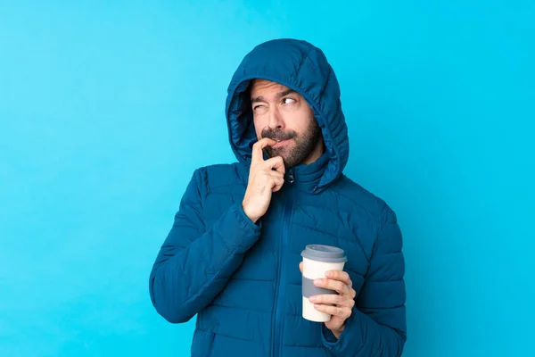 Man Wearing Winter Jacket Holding Takeaway Coffee Isolated Blue Background — Foto Stock