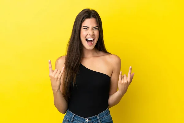 Young Brazilian Woman Isolated Yellow Background Making Horn Gesture — Foto Stock