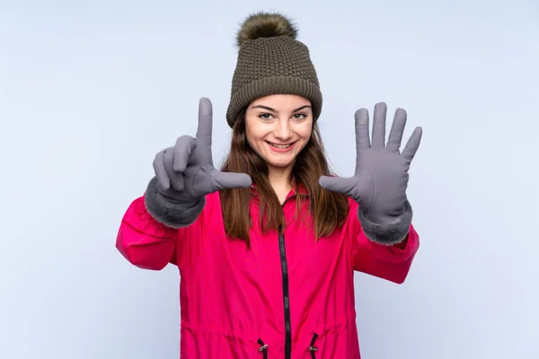 Young Girl Winter Hat Isolated Blue Background Counting Seven Fingers — 스톡 사진