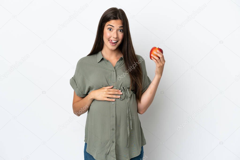 Young Brazilian woman isolated on white background pregnant and holding an apple
