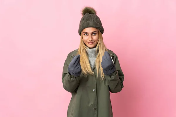 Jovem Com Chapéu Inverno Isolado Fundo Rosa Fazendo Gesto Dinheiro — Fotografia de Stock