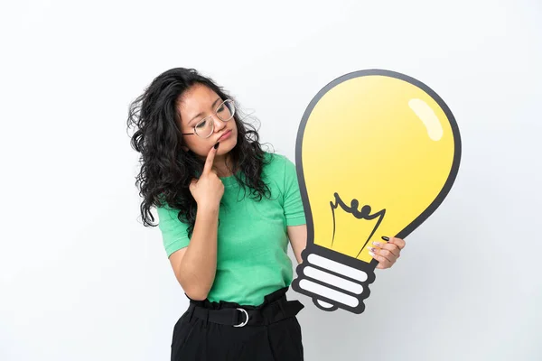 Young Asian Woman Isolated White Background Holding Bulb Icon Having — Stock Photo, Image