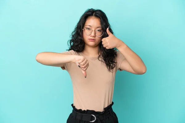 Young Asian Woman Isolated Blue Background Making Good Bad Sign — Stock Photo, Image