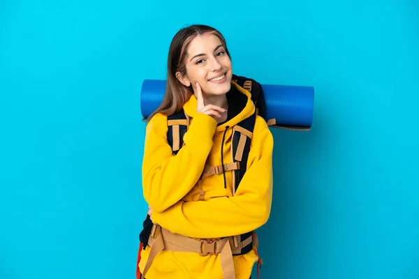 Young Mountaineer Woman Big Backpack Isolated Blue Background Thinking Idea — Stock Photo, Image