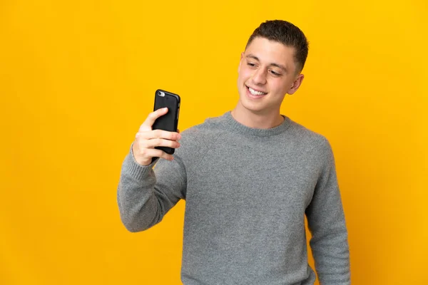 Junger Kaukasier Isoliert Auf Gelbem Hintergrund Und Macht Ein Selfie — Stockfoto
