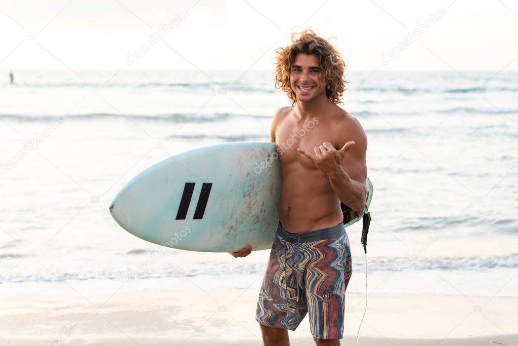 Young caucasian man get up early to  doing surf at sunrise