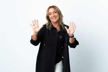 Orta yaşlı sarışın kadın izole edilmiş beyaz arka planda on parmaklı sayıyor.