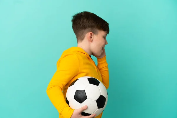 Roodharige Kind Spelen Voetbal Geïsoleerd Blauwe Achtergrond Schreeuwen Met Mond — Stockfoto