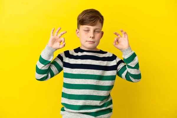 Little Redhead Boy Isolated Yellow Background Zen Pose — Stock Photo, Image