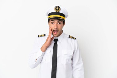 Airplane pilot over isolated white background with surprise and shocked facial expression