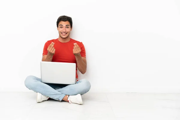 Caucasian Handsome Man Laptop Sitting Floor Making Money Gesture — Stok fotoğraf