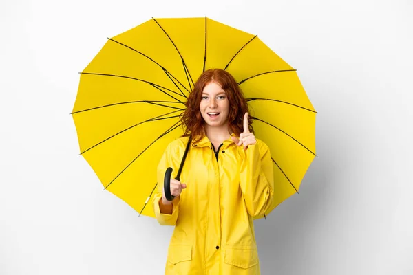 ティーネージャーRedhead女の子レインプルーフコートと傘隔離された上に白の背景考え方指アップ — ストック写真