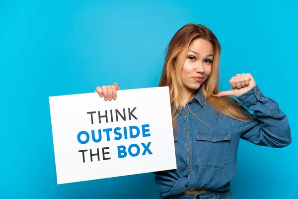 Nastolatka Nad Odizolowanym Niebieskim Tle Trzymając Tabliczkę Tekstem Pomyśl Poza — Zdjęcie stockowe