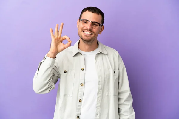 Brazilský Muž Přes Izolované Fialové Pozadí Ukazující Znamení Prsty — Stock fotografie