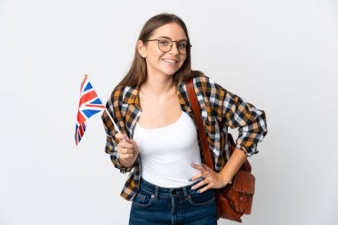 Young Lithuanian woman holding an United Kingdom flag isolated on white background posing with arms at hip and smiling