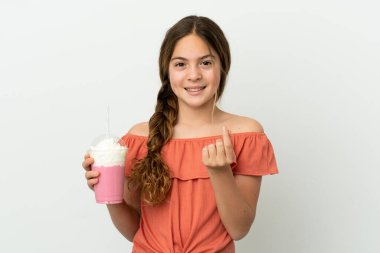 Beyaz arka planda izole edilmiş çilekli milkshake 'li küçük beyaz kız para hareketi yapıyor.