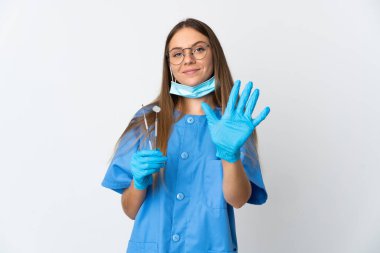 Lithuanian woman dentist holding tools over isolated background counting five with fingers