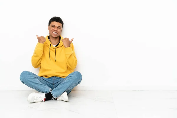 Young African American Man Sitting Floor Isolated White Background Thumbs — Stock Fotó
