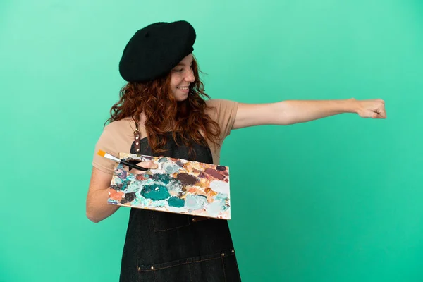 Teenager Redhead Artist Holding Palette Isolated Green Background Giving Thumbs — Stock Photo, Image