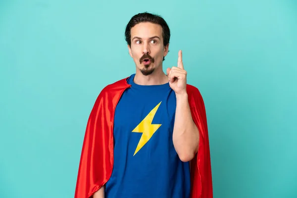 Super Hero Caucasian Man Isolated Blue Background Thinking Idea Pointing — Stock Photo, Image