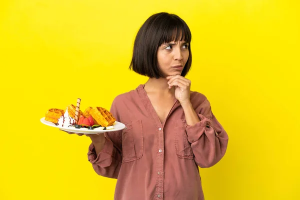 Pregnant Woman Holding Waffles Isolated Yellow Background Having Doubts Thinking — Stock Photo, Image