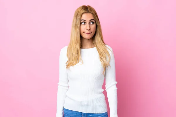 Jovem Mulher Loira Uruguaia Sobre Fundo Rosa Isolado Com Dúvidas — Fotografia de Stock