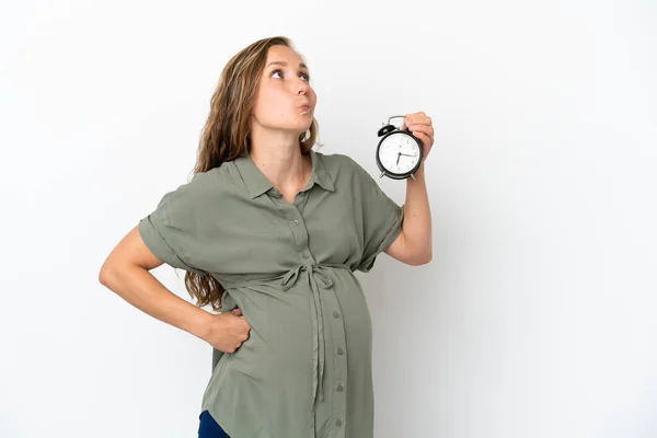 Young Caucasian Woman Isolated White Background Pregnant Holding Clock While — Fotografia de Stock