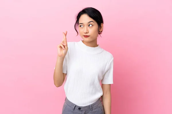 Young Vietnamese Woman Isolated Pink Background Fingers Crossing Wishing Best —  Fotos de Stock