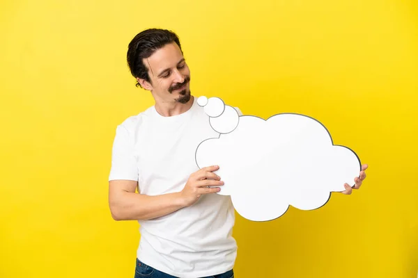 Young Caucasian Man Isolated Yellow Background Holding Thinking Speech Bubble — Stock Photo, Image