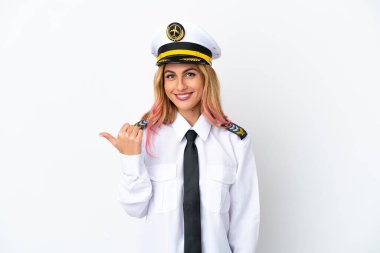 İzole edilmiş beyaz arka plan üzerinde uçak pilotu bir ürünü sunmak için kenarı işaret ediyor