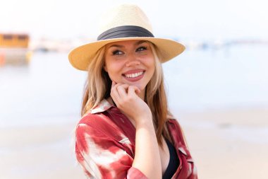 Yaz tatilinde kumsalda güzel sarışın bir kız.