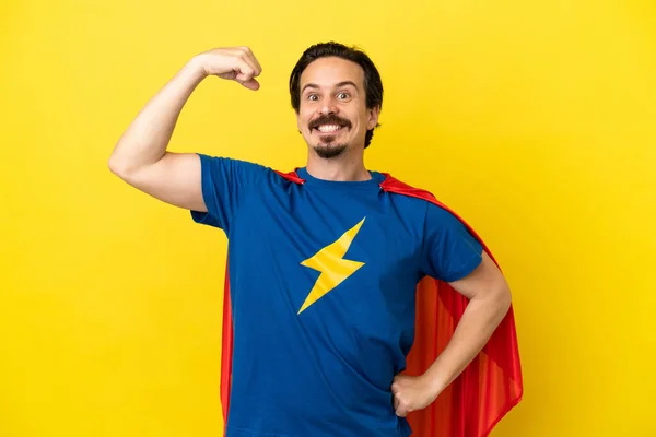 Young Caucasian Man Isolated Yellow Background Superhero Costume Doing Strong — Stock Photo, Image