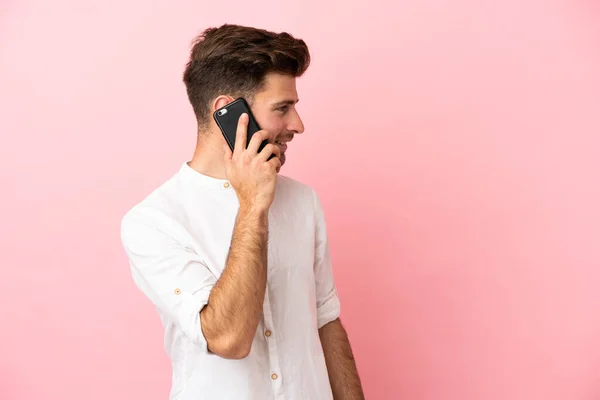 Young Caucasian Handsome Man Isolated Pink Background Keeping Conversation Mobile — Stock Photo, Image