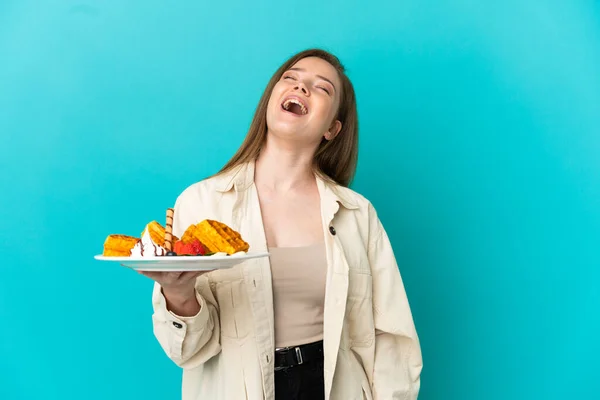 Teenager Girl Holding Waffles Isolated Blue Background Laughing — Stock Photo, Image