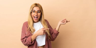 Genç Uruguaylı sarışın kadın soyutlanmış geçmişine şaşırmış ve işaret ediyor.