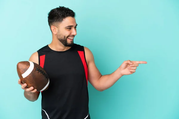 Mladý Arabský Muž Hraje Rugby Izolované Modrém Pozadí Ukazující Prstem — Stock fotografie