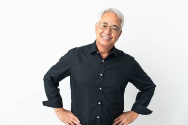 Middle age Brazilian man isolated on white background posing with arms at hip and smiling
