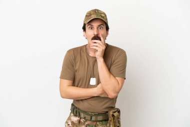 Soldier man isolated on white background surprised and shocked while looking right