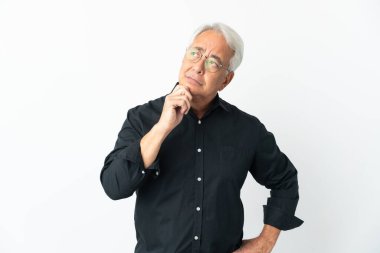 Middle age Brazilian man isolated on white background having doubts and thinking