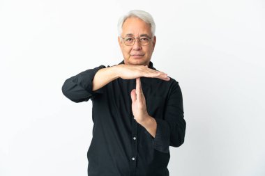 Middle age Brazilian man isolated on white background making time out gesture