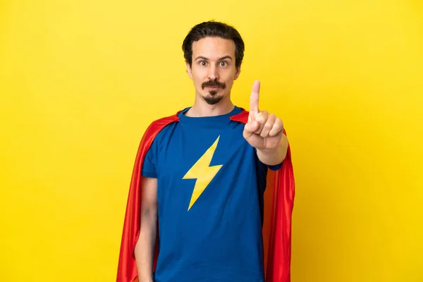 Young Caucasian Man Isolated Yellow Background Superhero Costume Pointing Front —  Fotos de Stock