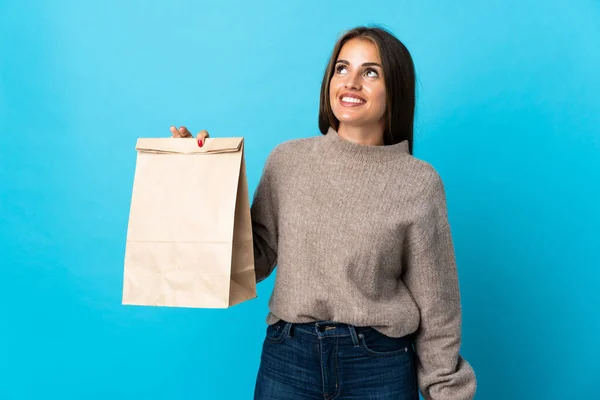 Woman Taking Bag Takeaway Food Isolated Blue Background Thinking Idea — Stock Fotó